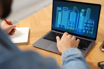 Building information modeling. Man working at laptop indoors, closeup. Digital project on computer...