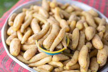 Yellow boiled potatoes are placed on a tray ready for sale.