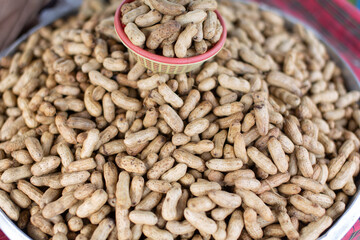 Peanuts, boiled and yellow, placed on a tray ready for sale.