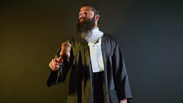 Bearded magistrate holds gavel calling for order
