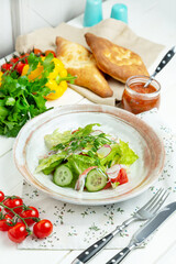 Crab meat salad with fresh vegetables in a plate, restaurant. Vertical frame.