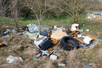 Illegal waste dump in the forest. Ecological disaster. Human stupidity, pollution of our own...