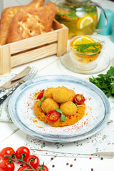 Cheese balls on a plate, restaurant. Vertical frame.