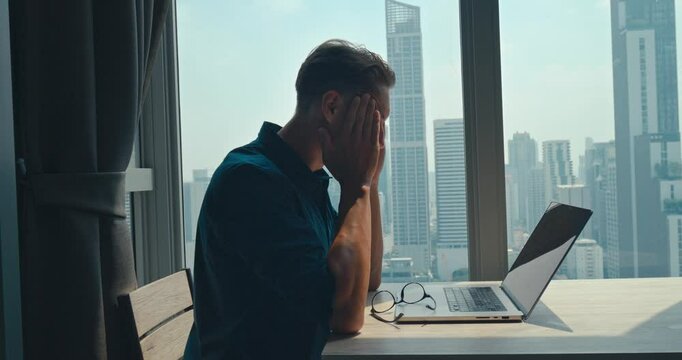 Tired Manager planning crucial meeting from high-rise apartment, manager orchestrating team goals with city inspiration, manager elevating productivity, versatile for corporate success stories.