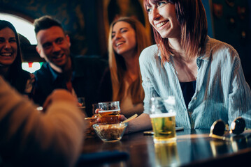 Group of teens having fun in a pub