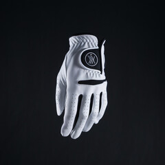 A photo of a white golf glove against a completely black background. The deep black background provides a stark contrast.