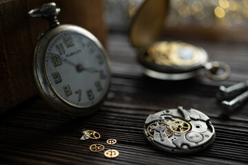 Mechanical watch assembly, watchmaker's workshop with many parts and gears