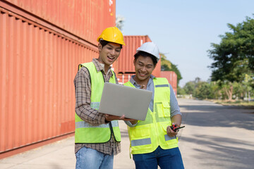 Team Collaboration. Engineers sharing insights on logistics with a laptop.