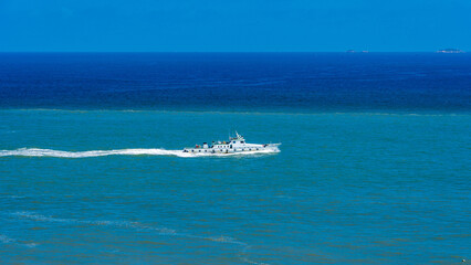 A Majestic Boat Navigating the Vibrant Blue Ocean Waters