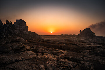 Sun rising between hornitos in Erta Ale volcano in Afar region, Ethiopia