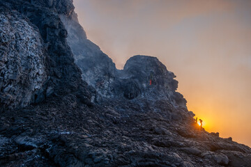 Sun rising behind a fuming hornito in Erta Ale volcano in Afar region, Ethiopia