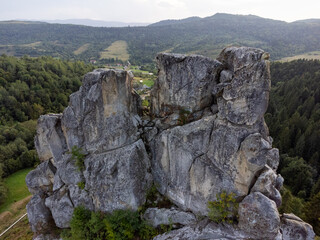 Aerial view of Tustan fortress ruins surrounded by autumn forest in Ukraine