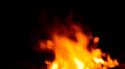 Blurred flames against a dark background, creating a warm, intense, and abstract fire effect.