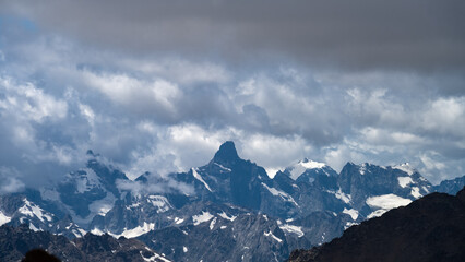 snowy mountain peaks in the clouds