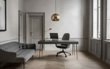 Modern home office with gray sofa, desk, and gold lamp.