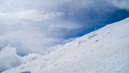 snowy mountain peaks in the clouds