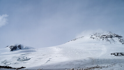 snowy mountain peaks in the clouds