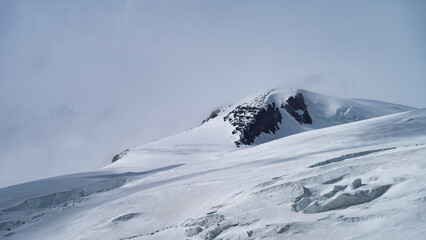 snowy mountain peaks in the clouds