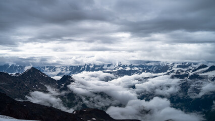 snowy mountain peaks in the clouds