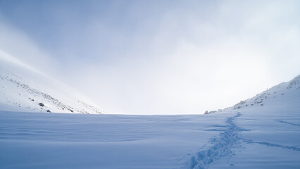 snowy mountain peaks in the clouds