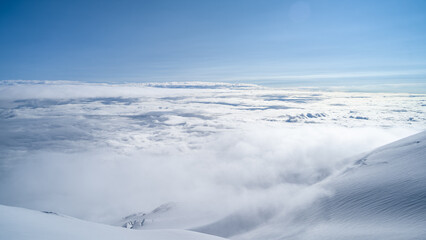 snowy mountain peaks in the clouds
