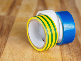 A roll of black insulating tape, its texture and shine. A close-up of a basic tool for electrical...