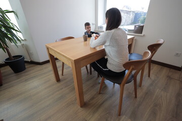 Fototapeta premium Mother and a boy spending time together playing indoors