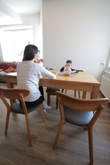 Mother and a boy spending time together playing indoors