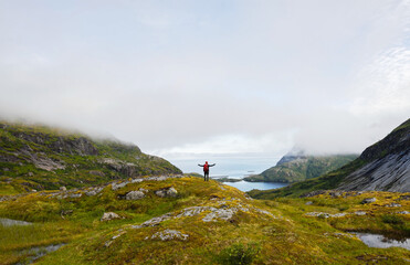 A Solo Adventurer Fully Embracing Natures Majestic Beauty in Stunning Norways Landscape