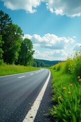 Newly paved grey asphalt road, lush green grass verge , roadside, environment, drive