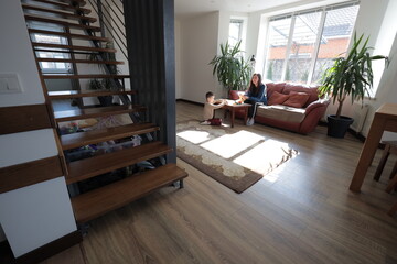 Mother and a boy child play together indoors