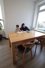 Mother and a boy child play together indoors