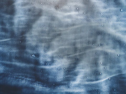 Acid-washed denim with irregular patterns flowing naturally for a vintage fabric effect