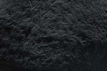 Dark rock texture with shadow, ideal for minimalist and abstract designs. Mockup for presentation, branding products, cosmetics, food, technology or jewelry. Premium background..