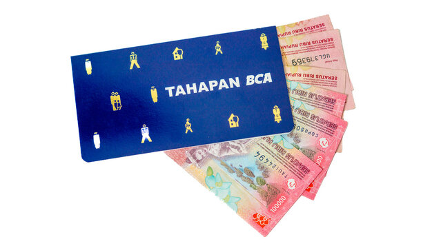 Saving book (buku tabungan) of Bank Central Asia (BCA) and Indonesian currency.