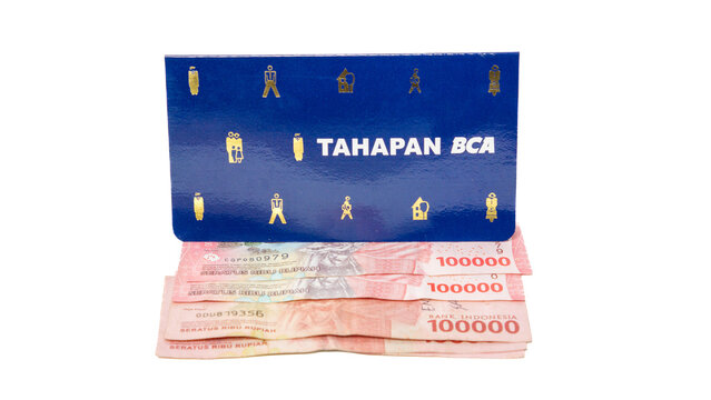 Saving book (buku tabungan) of Bank Central Asia (BCA) and Indonesian currency.