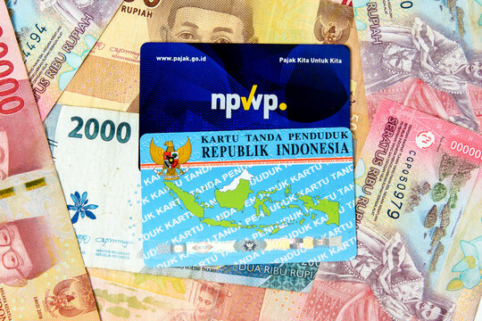 Indonesian tax card (Kartu NPWP) and identity card on the Indonesian currency