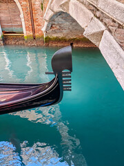 The gondola are on the narrow canal in Venice © vadiml