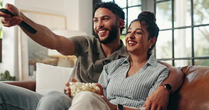 Playful, TV and couple relax on sofa for watching movies, film or series on streaming subscription in home. Love, happy and man with woman on couch for entertainment, bonding or videos in living room