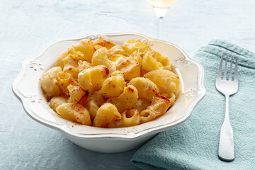 Mac and cheese, the classic pasta with macaroni and Cheddar cheese, baked in the oven, with a fork