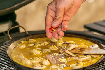 The chef prepares a traditional seafood paella on the grill.Traditional spanish dish. Fresh and Colorful Spanish Seafood Paella. Mediterranean cuisine and seafood dishes.