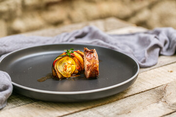 Chef preparing traditional Provençal vegetable dish Ratatouille with stuffed rolled meat on the grill. French food. Healthy eating. Delicious vegetable