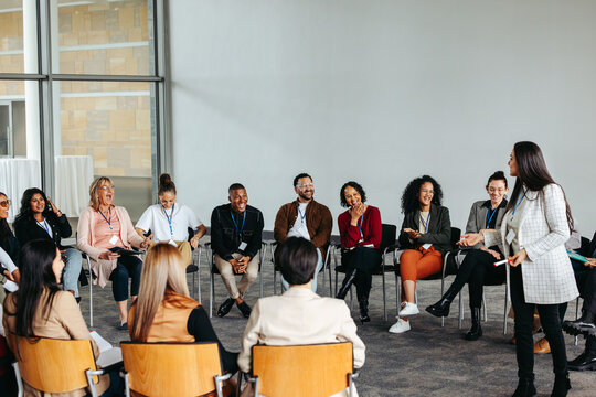 Motivational speaker engaging with an audience in a lively conference setting
