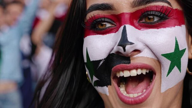 Passionate Syrian sports fan with bold flag face paint cheering at a stadium  
