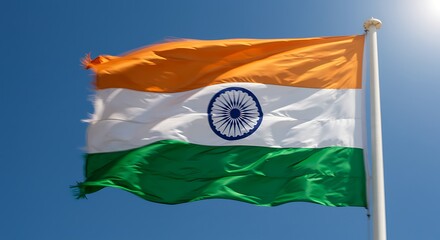 Waving Indian National Flag Against Clear Blue Sky on Bright Day