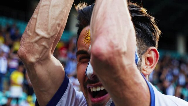 Proud Uruguayan sports fan with artistic flag face paint at a stadium  
