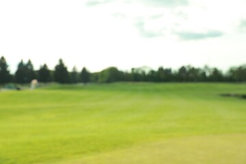 Blurred view of golf course on sunny day