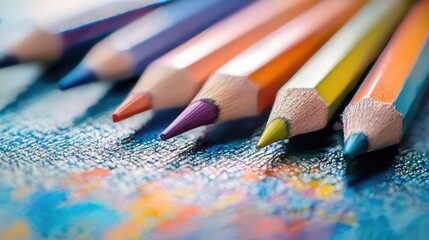 Obraz premium Vibrant colored pencils arranged neatly on a white surface ready for artistic creations