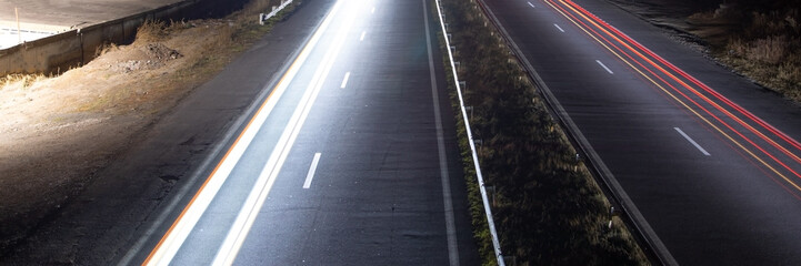 Highway car light trails at night.