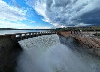 Dam  overflowing with dark clouds
